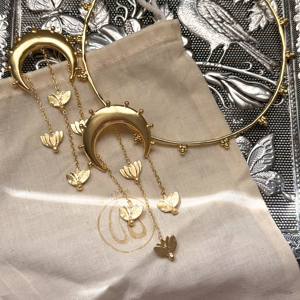 Nilofer crescent and lotus tassel earrings styled in a lifestyle setting