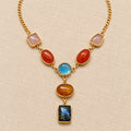 Gold-tone pendant necklace with rose quartz, carnelian, blue chalcedony, citrine, and labradorite gemstones