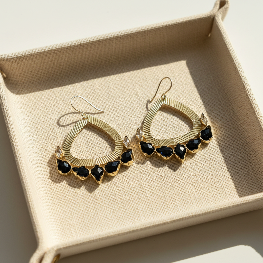 Natural product photograph of the Nora Earrings resting on linen