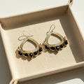Natural product photograph of the Nora Earrings resting on linen
