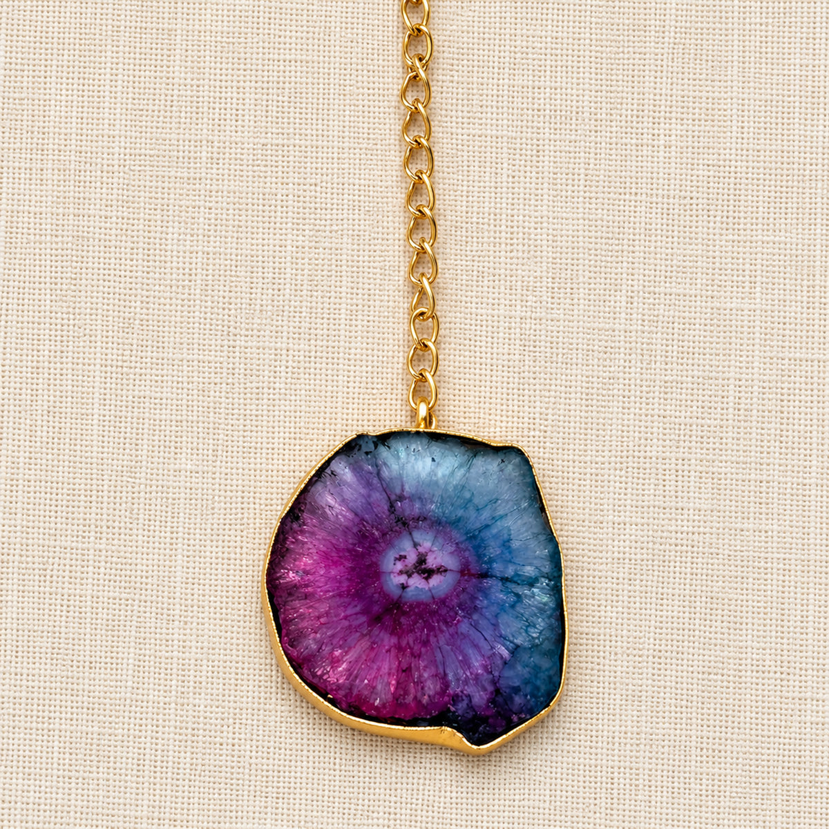 Natural irregular agate pendant suspended from the Prism gold-tone collar necklace